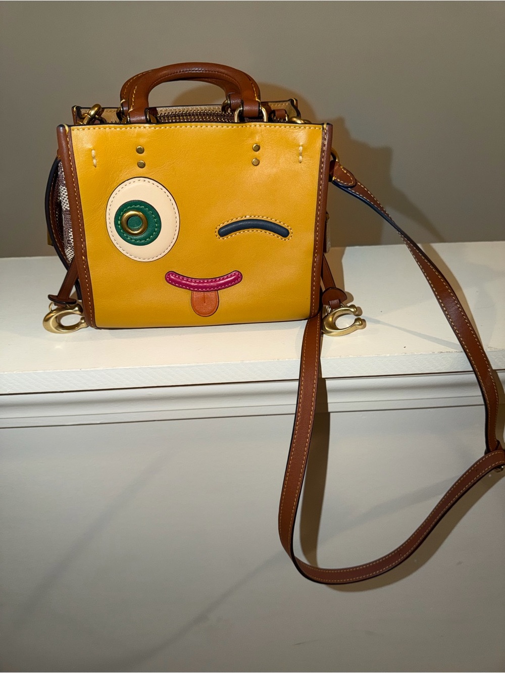 Yellow Faux-Leather Winking Face Crossbody Bag with Brown Trim